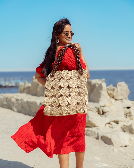 A Rectangular Wicker Bag Braided With Hand-Shaped Beads