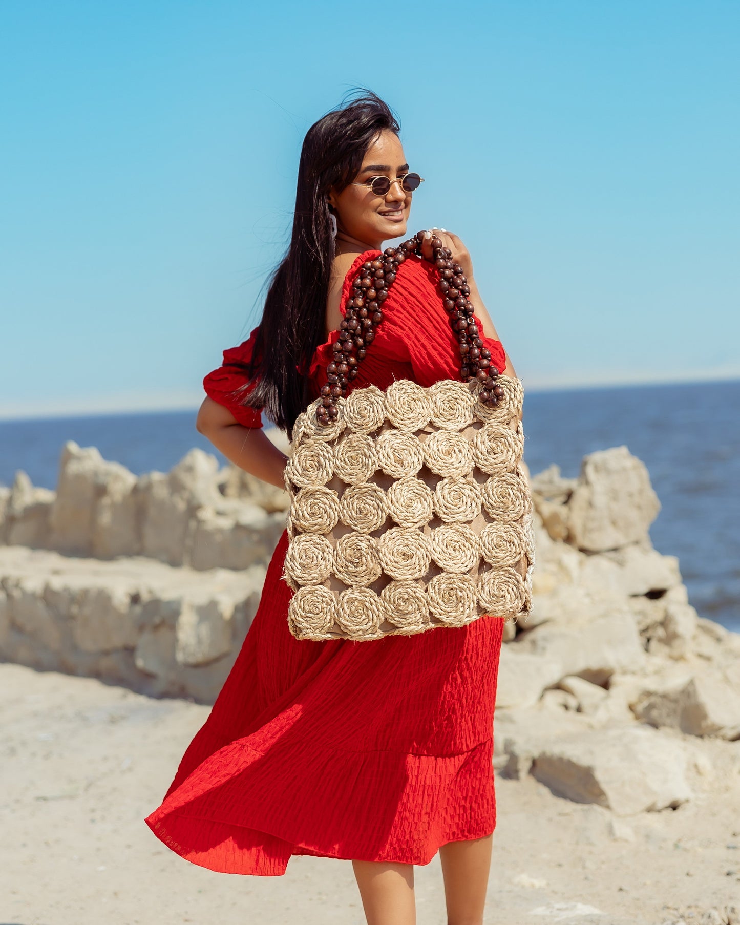 A Rectangular Wicker Bag Braided With Hand-Shaped Beads