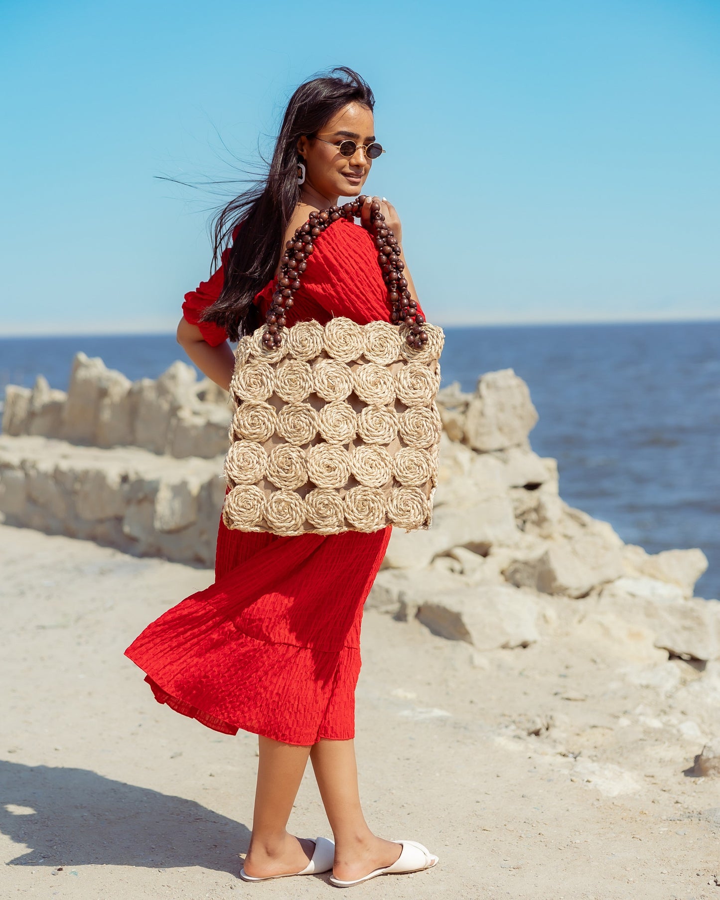 A Rectangular Wicker Bag Braided With Hand-Shaped Beads