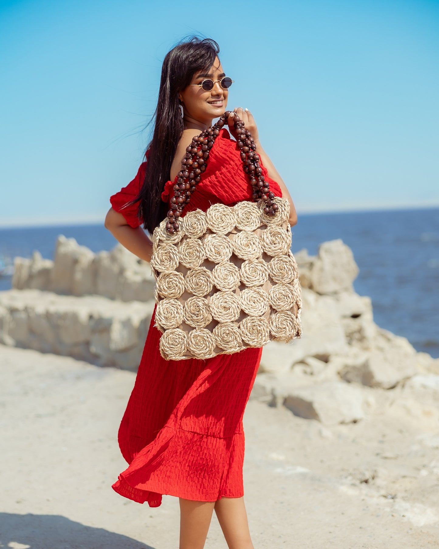 A Rectangular Wicker Bag Braided With Hand-Shaped Beads