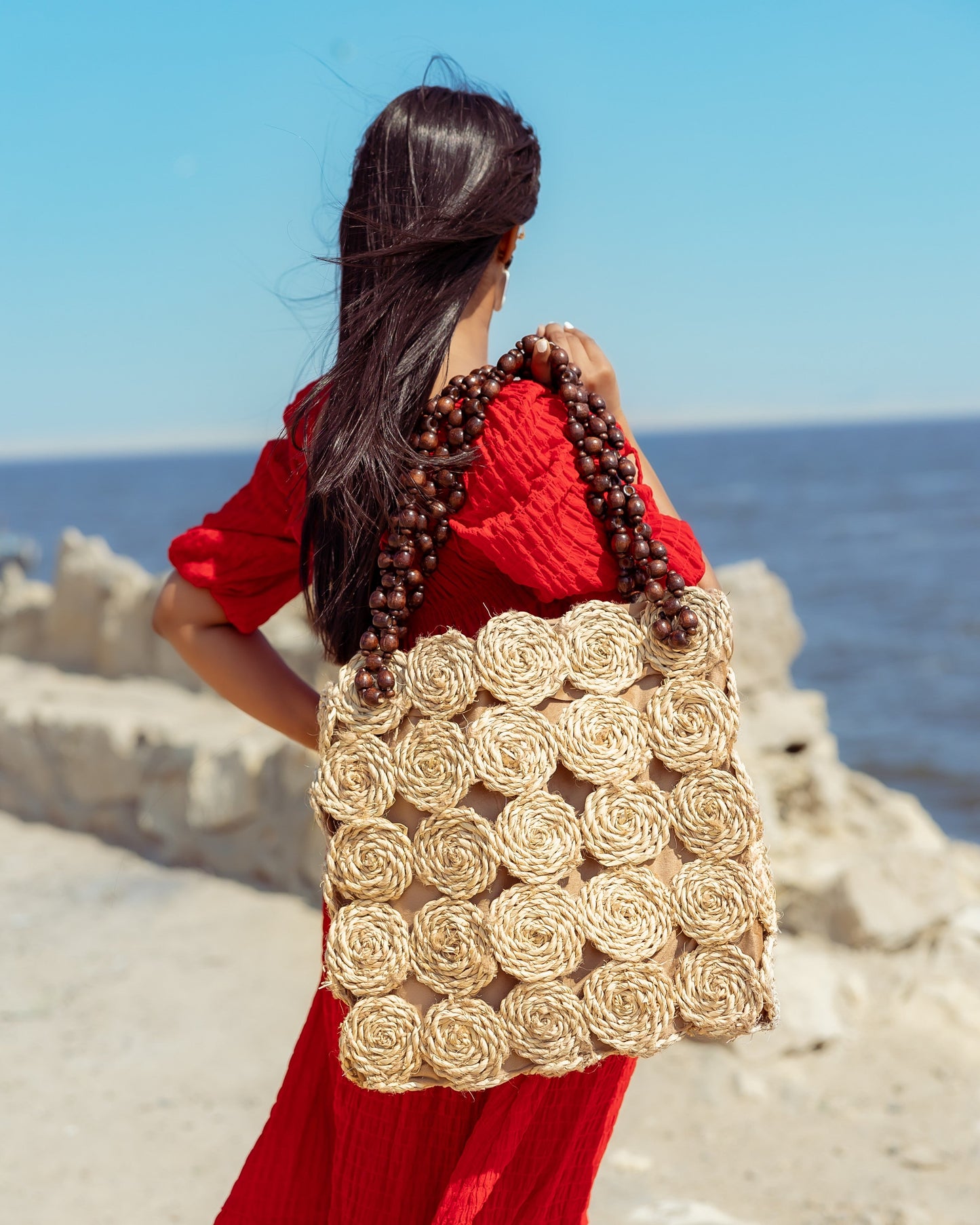 A Rectangular Wicker Bag Braided With Hand-Shaped Beads