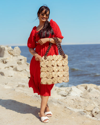 A Rectangular Wicker Bag Braided With Hand-Shaped Beads