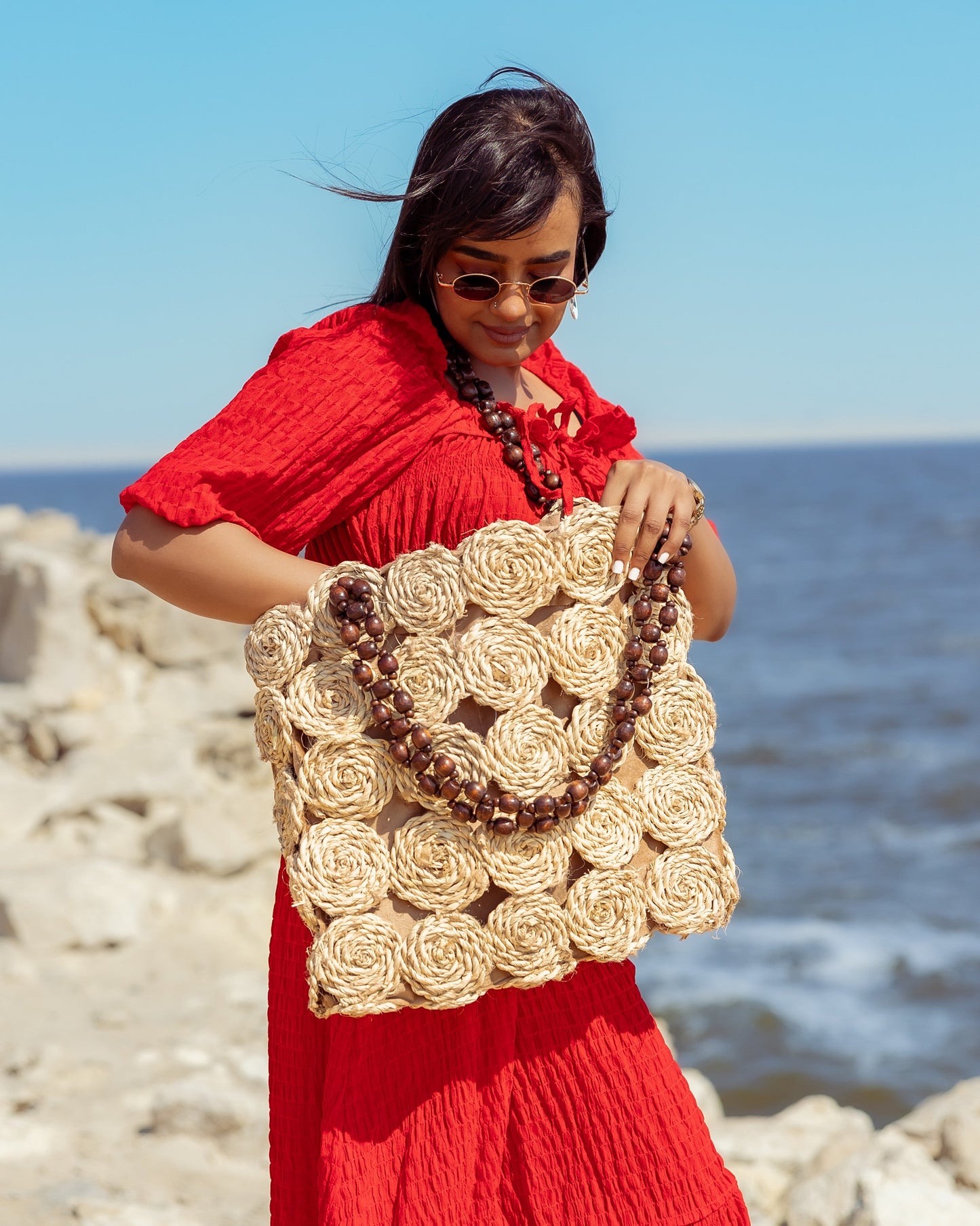 A Rectangular Wicker Bag Braided With Hand-Shaped Beads