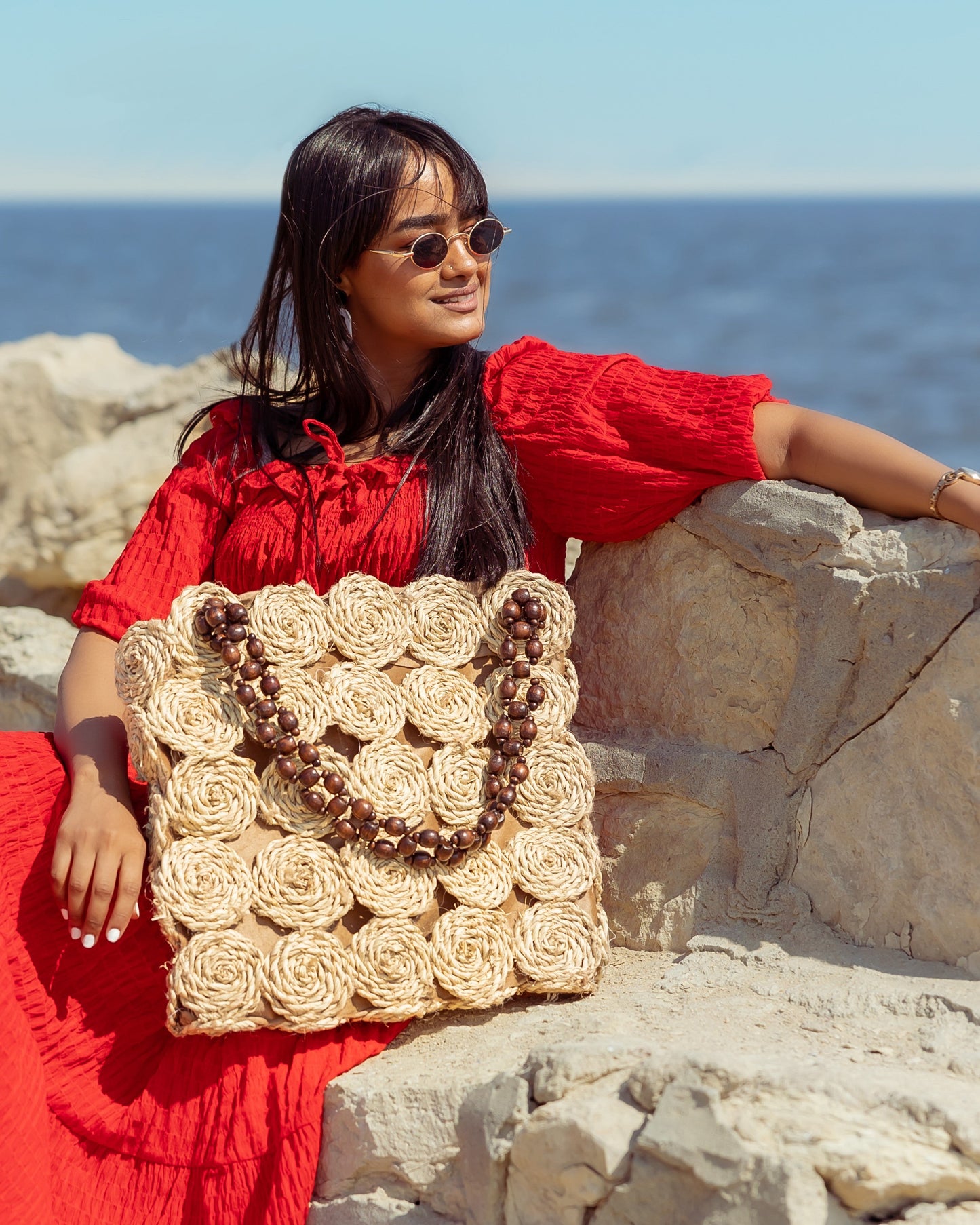 A Rectangular Wicker Bag Braided With Hand-Shaped Beads