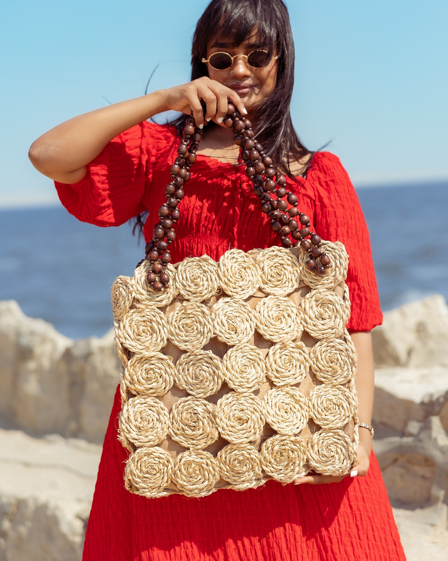 A Rectangular Wicker Bag Braided With Hand-Shaped Beads