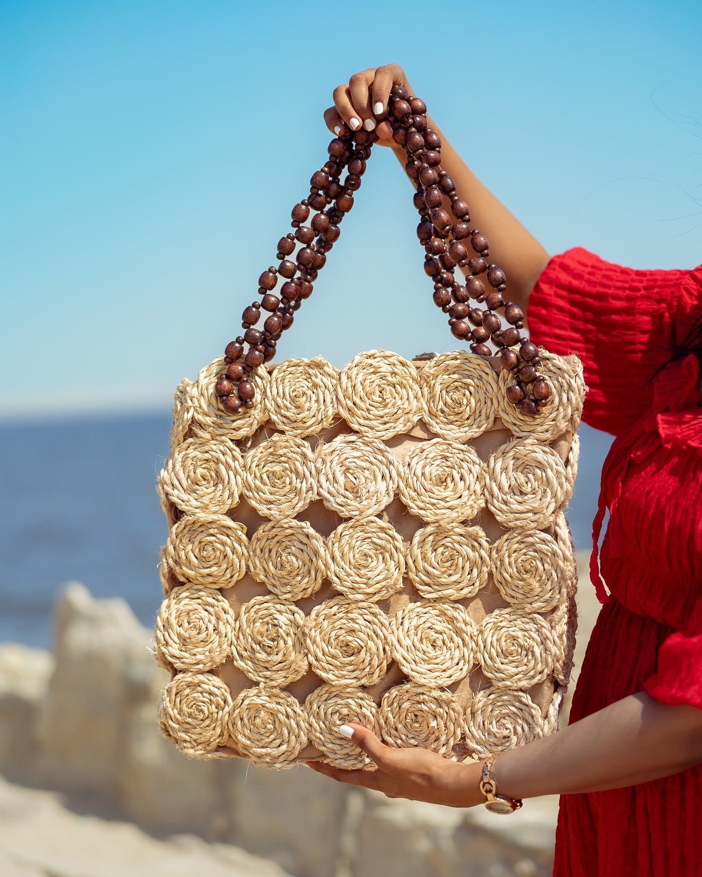 A Rectangular Wicker Bag Braided With Hand-Shaped Beads